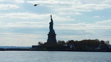One helicopter flying over in the blue sky in autumn photo