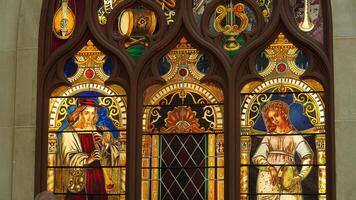 The church windows view with the religious glass drawings on them photo