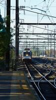 The train station view with the iron tracks near the platform photo