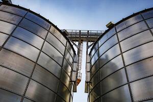 silos on agro-industrial complex with seed cleaning and drying line for grain storage. Granary elevator photo