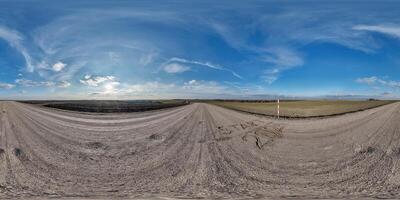 hdri 360 panorama on gravel road among fields with sign 2024 start on sand at evening with clouds in equirectangular full seamless spherical projection, for VR AR virtual reality content photo