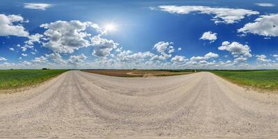 blue sky hdri 360 panorama with awesome clouds on gravel road among fields in equirectangular full seamless spherical projection, for VR AR content or skydome replacement photo