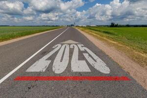 numbers 2024, 2025 on asphalt road highway. concept of destination in future, freedom, work start, run, planning, challenge, target, new year photo