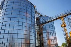 silos on agro-industrial complex with seed cleaning and drying line for grain storage. Granary elevator photo