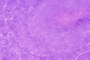 Blue water with ripples on the surface. Defocus blurred transparent blue colored clear calm water surface texture with splashes and bubbles. Water waves with shining pattern texture background. photo