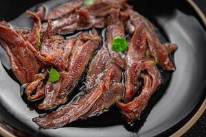 anchovies in a plate on the table canned fish in oil fresh and tasty seafood meal food snack on the table copy space food background rustic photo