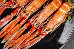 langoustine tasty seafood shrimp prawns delicious fresh meal food snack on the table copy space food background rustic top view keto or paleo diet Pescetarian photo