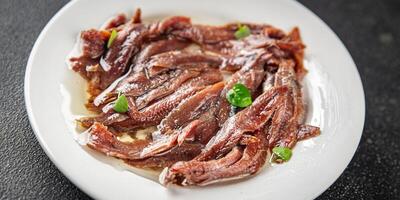 anchovies in a plate on the table canned fish in oil fresh and tasty seafood meal food snack on the table copy space food background rustic photo