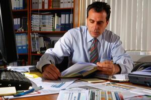 An accountant at work at his desk. AI generate photo
