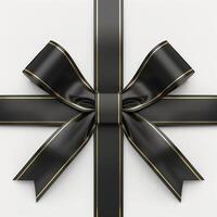 Black cross bow ribbon with gold edges on a white background. photo