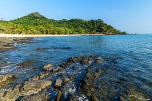 landscape of Farang Beach or Charlie Beach, there are many rock on the sandy beach photo