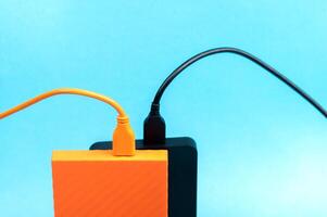 Multicolored external portable hard disk drives isolated on blue background photo