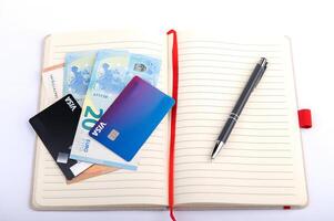 money and pen on an open planner, financial analytics concept, calculating budget, currency balance photo