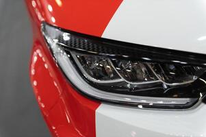 Closeup of a modern car s LED red taillight signaling turning on street to maintain distance with a closeup of the trunk photo