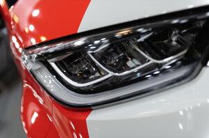 Closeup of a modern car s LED red taillight signaling turning on street to maintain distance with a closeup of the trunk photo