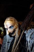 Spooky Halloween decoration stands in a wooded area creating a sinister atmosphere photo