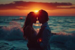 silhouette of a couple in love hugging on the seashore at sunset photo
