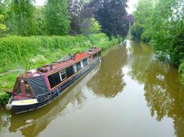 english canal with narrow old houseboats photo