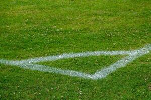 white corner markings on a football pitch photo
