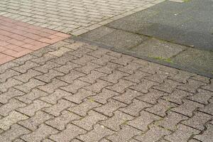 different paving stones on the sidewalk photo
