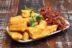 Shredded dried meat with fried cassava photo