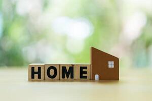 Model of home with text of HOME against natural background with copy space. photo
