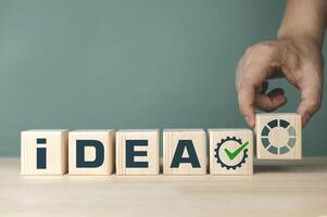 concept of ideas loading and new innovations. character on wooden blocks with copy space photo