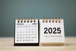 Calendar page January of year 2025 white color on table with copy space and business design. concept of planning and setting new strategic goals. photo