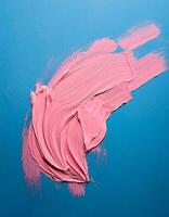 Abstract pink oil paint texture on blue canvas or wall. Minimalistic background with copy space. photo