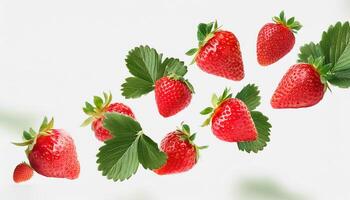 Flying juicy ripe strawberries with leaves isolated on a white background photo