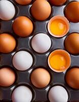 photo pallet with eggs and raw broken egg with yolk. Pattern texture background