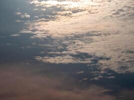 Fluffy clouds floating scattered across the sky photo