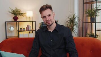 Young bearded man smiling, pointing to camera, choosing lucky winner, indicating, inviting, approve video