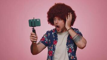 Man blogger take selfie on mobile phone selfie stick communicate call online with subscribers video