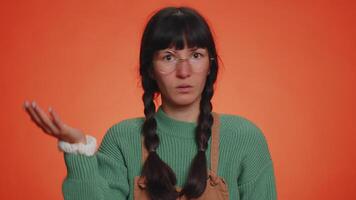 Young nerd woman pointing at camera and showing stupid gesture, blaming some fool for insane plan video