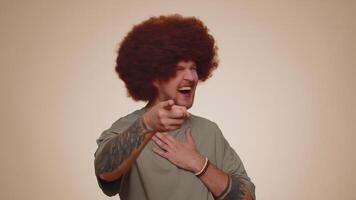 Man pointing finger to camera, laughing out loud, making fun of ridiculous appearance, funny joke video