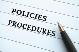 Policies and Procedures text on notepad. Company's policies and procedures concept. photo