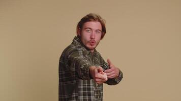 Mime young adult man pulling an imaginary unreal invisible rope showing how enduring, strong he is video