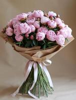 Pink Peonies Bouquet Wrapped in Brown Paper photo