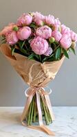 Pink Peonies Bouquet Wrapped in Brown Paper photo