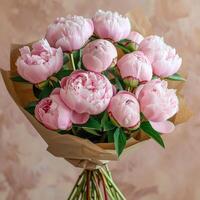 Bouquet of Pink Peonies Wrapped in Brown Paper photo