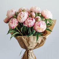 Bouquet of Pink Peonies Wrapped in Brown Paper photo