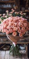 A Bouquet of Pink Roses on Wooden Table photo