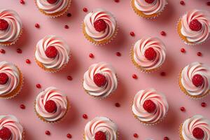 Cupcakes With White Frosting and Raspberries on Pink Surface photo
