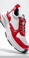 Red and White Sneakers on White Background photo
