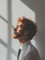 Man in White Shirt and Tie Standing in Front of Window photo