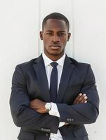 Man in Suit and Tie Standing With Arms Crossed photo