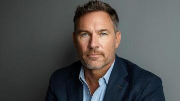 Man in Suit and Blue Shirt Posing for Picture photo