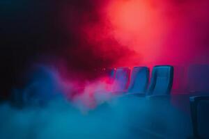 Row of chairs in foggy room photo
