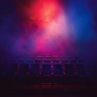 Row of empty chairs in front of stage photo